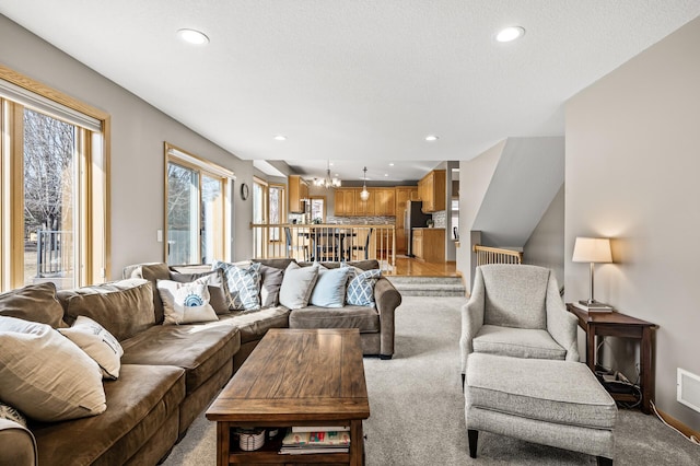 living area with recessed lighting, a chandelier, and light carpet