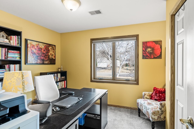 carpeted home office with visible vents and baseboards