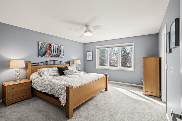 carpeted bedroom featuring baseboards and a ceiling fan