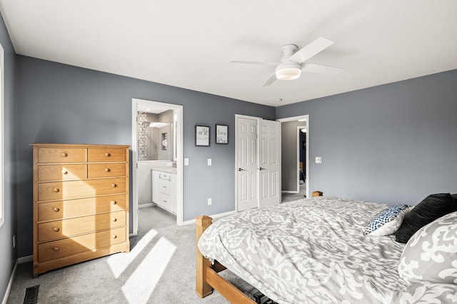 carpeted bedroom with a ceiling fan, baseboards, visible vents, a closet, and connected bathroom