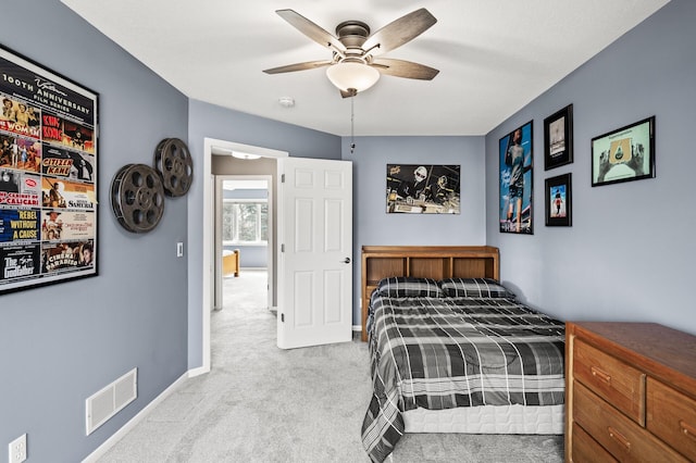 bedroom featuring visible vents, baseboards, carpet, and a ceiling fan