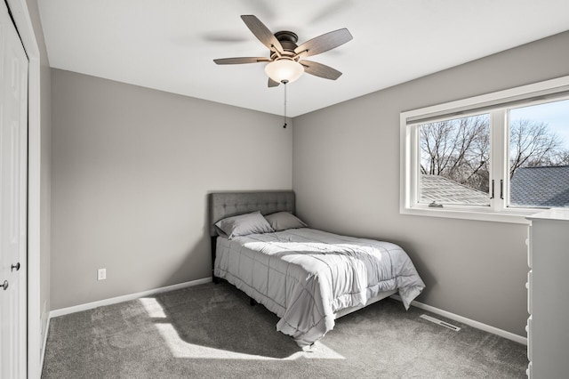 bedroom featuring visible vents, a ceiling fan, baseboards, and carpet floors