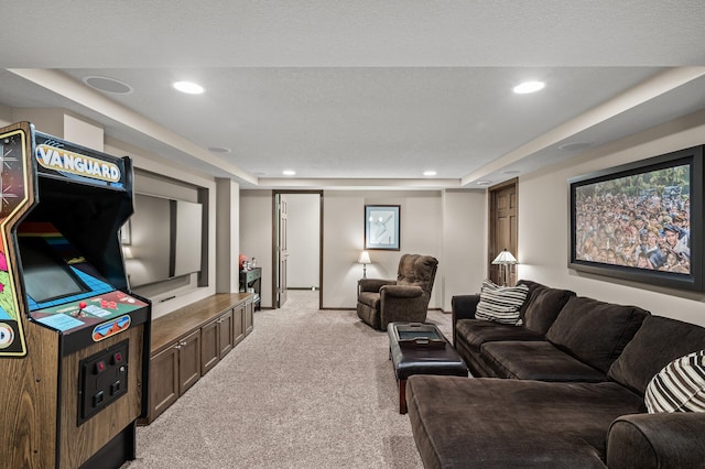 living area featuring recessed lighting, light carpet, a textured ceiling, and a raised ceiling