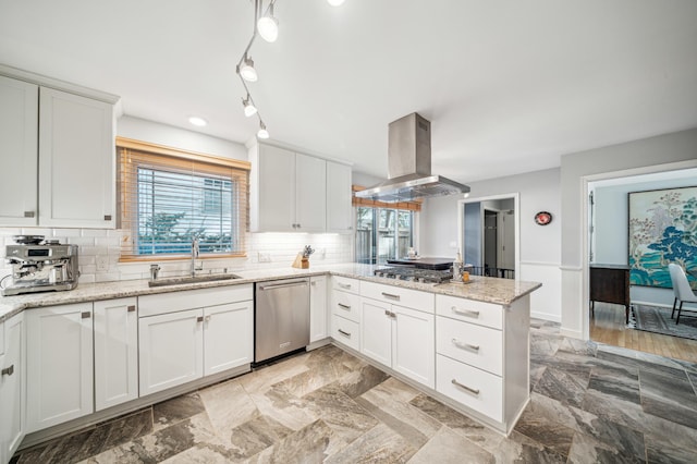 kitchen with appliances with stainless steel finishes, island range hood, sink, white cabinets, and kitchen peninsula