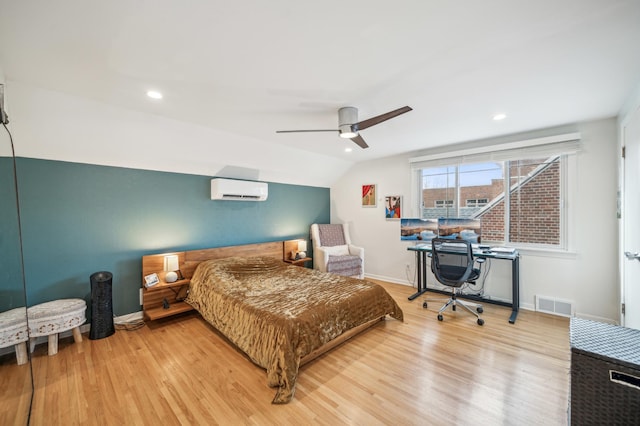 bedroom featuring ceiling fan, vaulted ceiling, hardwood / wood-style flooring, and a wall unit AC