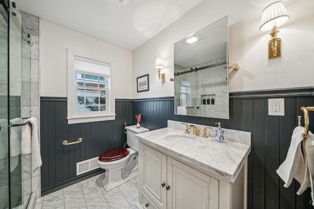 bathroom featuring toilet, an enclosed shower, and vanity