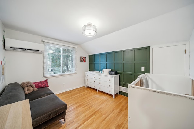 bedroom with wood-type flooring, a wall mounted AC, and lofted ceiling