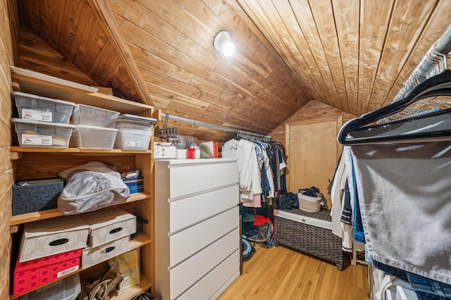 spacious closet featuring light wood-type flooring and vaulted ceiling