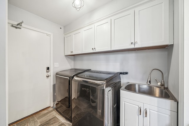 laundry room featuring sink, cabinets, and washing machine and clothes dryer