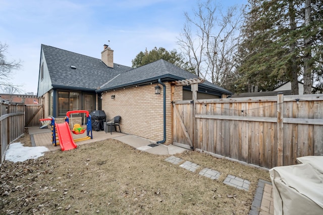 exterior space with a patio area, a playground, and a lawn