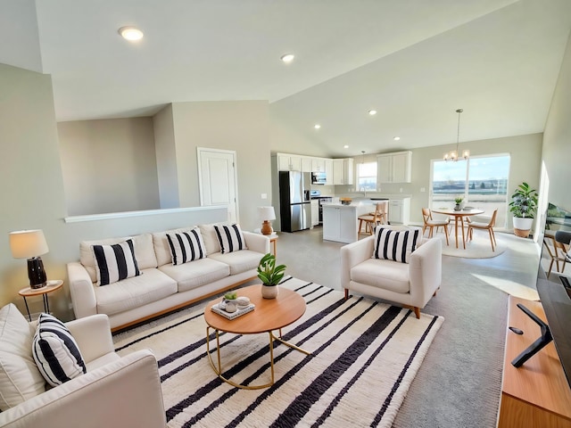 living room with a notable chandelier and vaulted ceiling