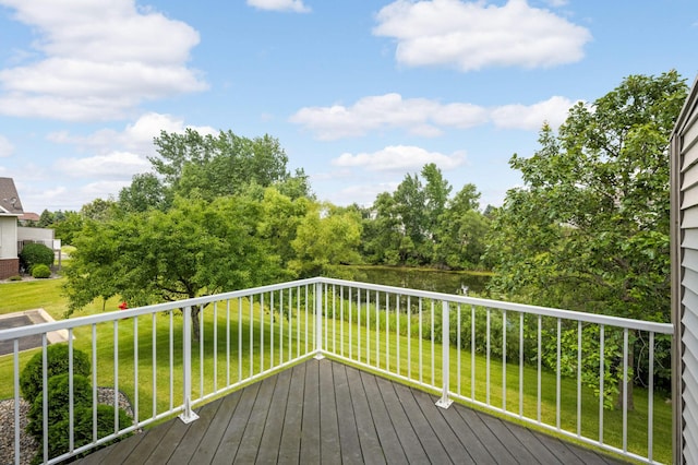 wooden terrace featuring a lawn