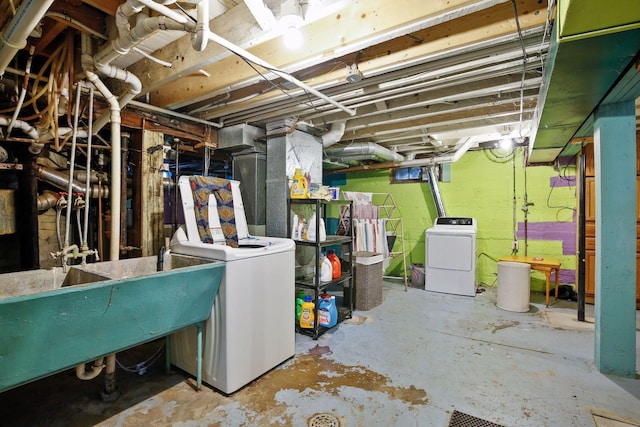 basement featuring separate washer and dryer and sink