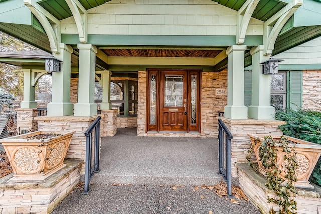 view of exterior entry featuring covered porch