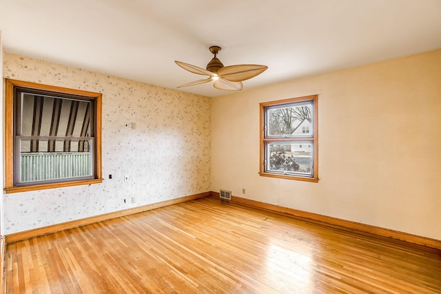 empty room featuring ceiling fan and wood-type flooring