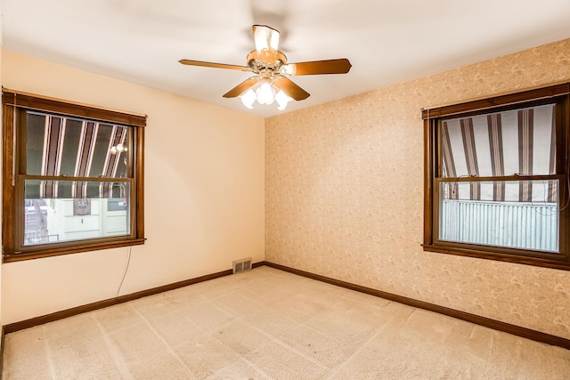 unfurnished room featuring ceiling fan and carpet floors