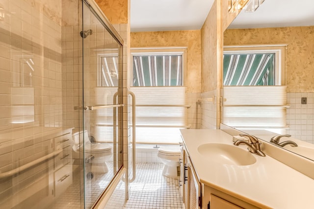 bathroom featuring tile patterned floors, vanity, toilet, and a shower with shower door