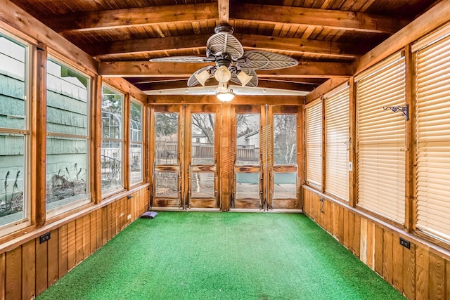 unfurnished sunroom with beamed ceiling, ceiling fan, and wooden ceiling