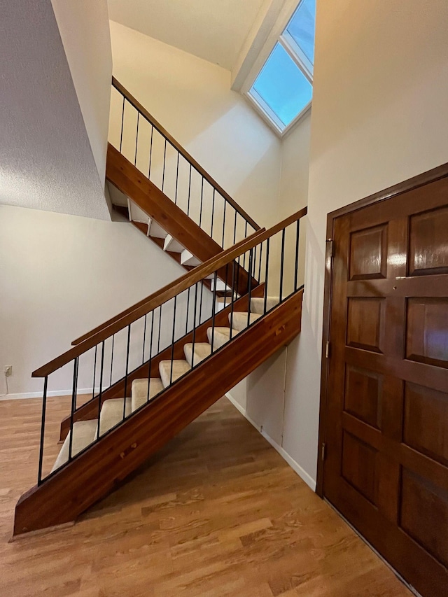 stairway featuring hardwood / wood-style flooring