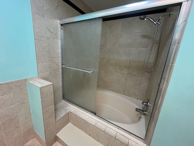 bathroom with shower / bath combination with glass door