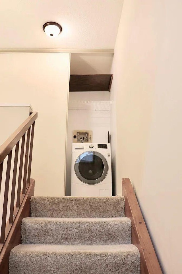 staircase featuring washer / dryer