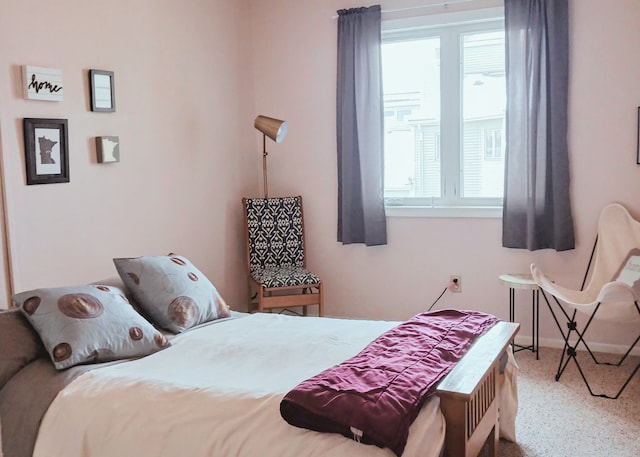 carpeted bedroom featuring multiple windows