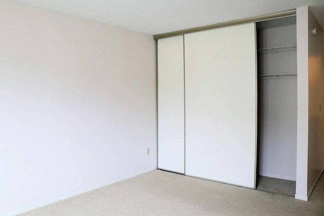 unfurnished bedroom with light carpet