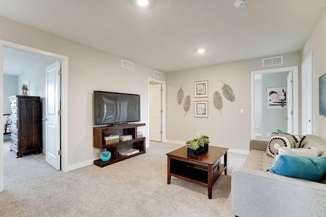 living room featuring light carpet, visible vents, and baseboards