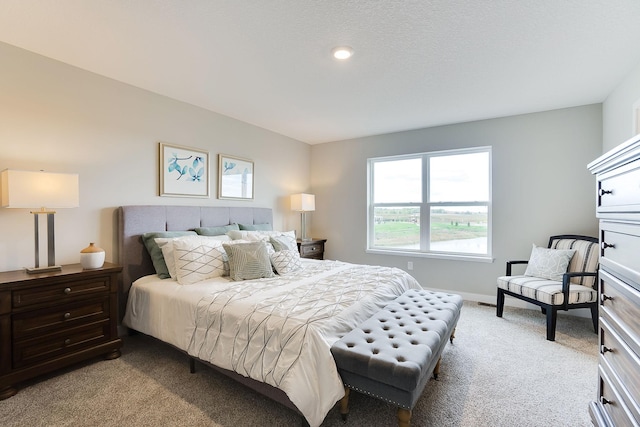 bedroom with light carpet and baseboards