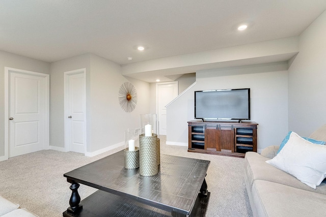 carpeted living area featuring baseboards and recessed lighting