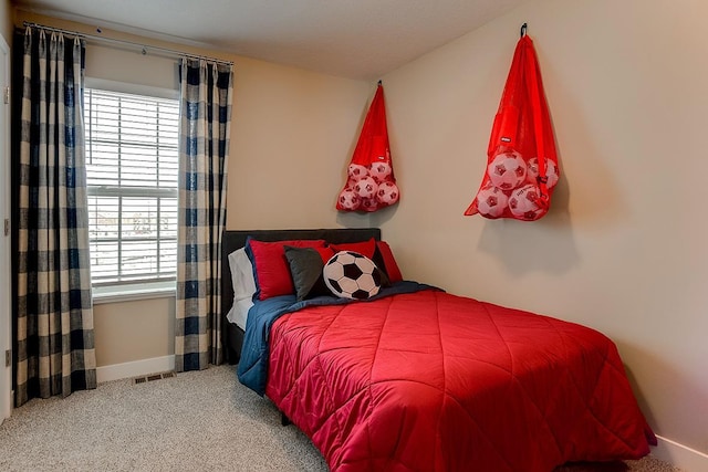 carpeted bedroom with multiple windows