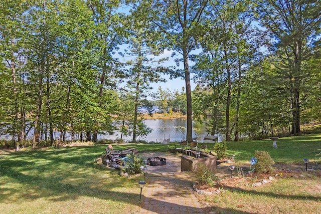 view of yard featuring a water view and an outdoor fire pit