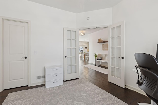 home office with baseboards, visible vents, dark wood-style flooring, and french doors