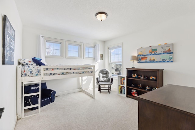 carpeted bedroom featuring a textured ceiling