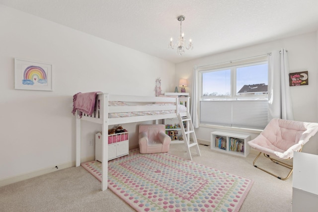 carpeted bedroom with a notable chandelier, a textured ceiling, and baseboards