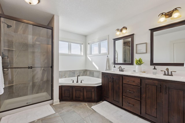 bathroom with a sink, a shower stall, and a bath