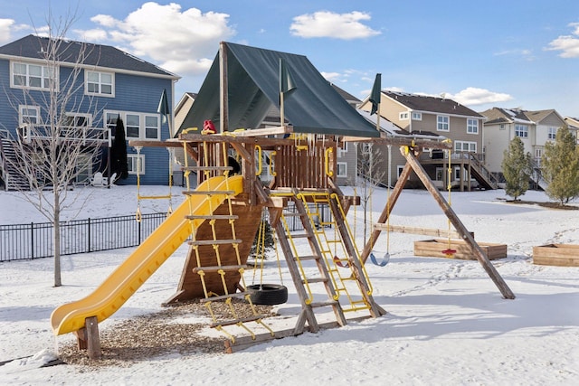 snow covered playground with a residential view and a playground