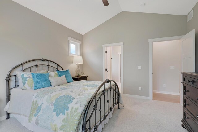 bedroom with light colored carpet, vaulted ceiling, and ceiling fan