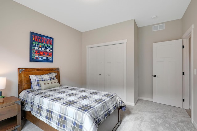 bedroom with a closet and light colored carpet