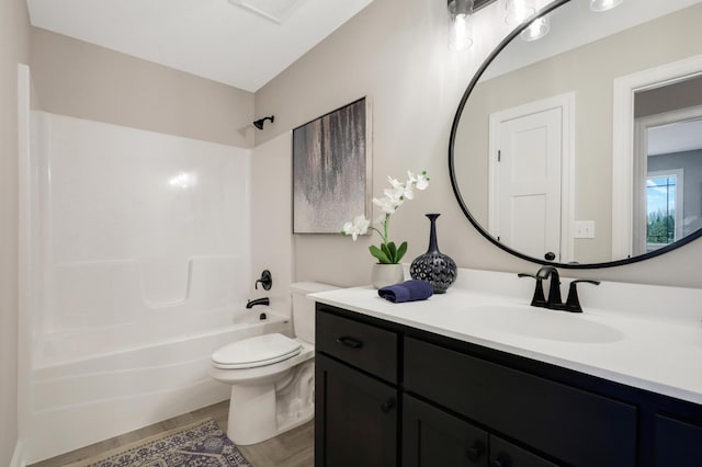 full bathroom with vanity, wood-type flooring, shower / bathtub combination, and toilet