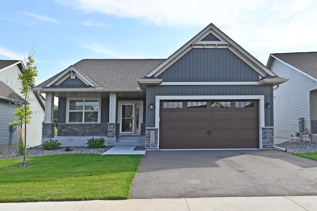 craftsman house featuring a front yard and a garage