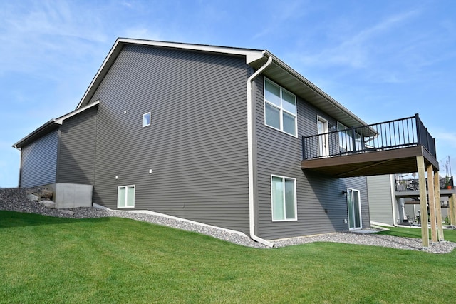 rear view of house with a yard and a wooden deck