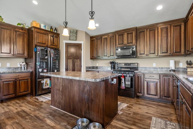 kitchen with stainless steel gas stove, black fridge with ice dispenser, dark wood-style floors, a kitchen island, and hanging light fixtures