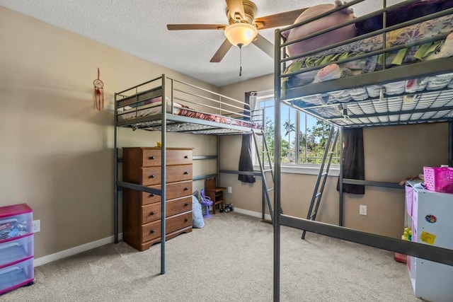 carpeted bedroom with baseboards and a textured ceiling
