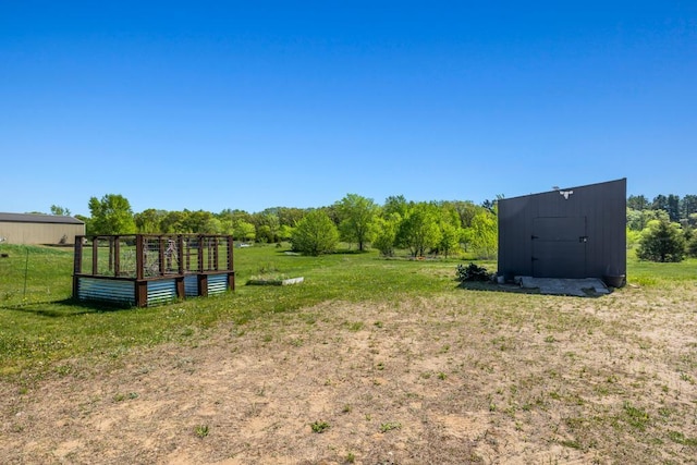 view of green lawn with an outdoor structure and a shed