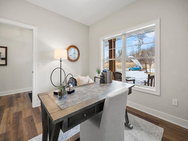 home office with dark hardwood / wood-style flooring