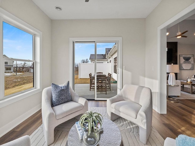 sitting room featuring ceiling fan and dark hardwood / wood-style floors