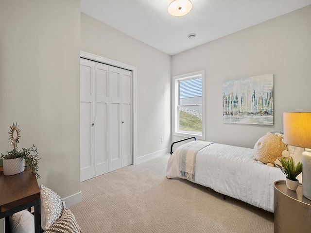 bedroom with light carpet and a closet