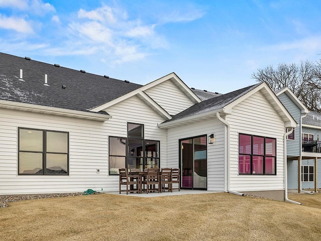 back of house featuring a yard and a patio