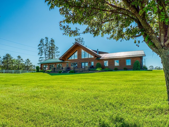 back of property featuring a yard